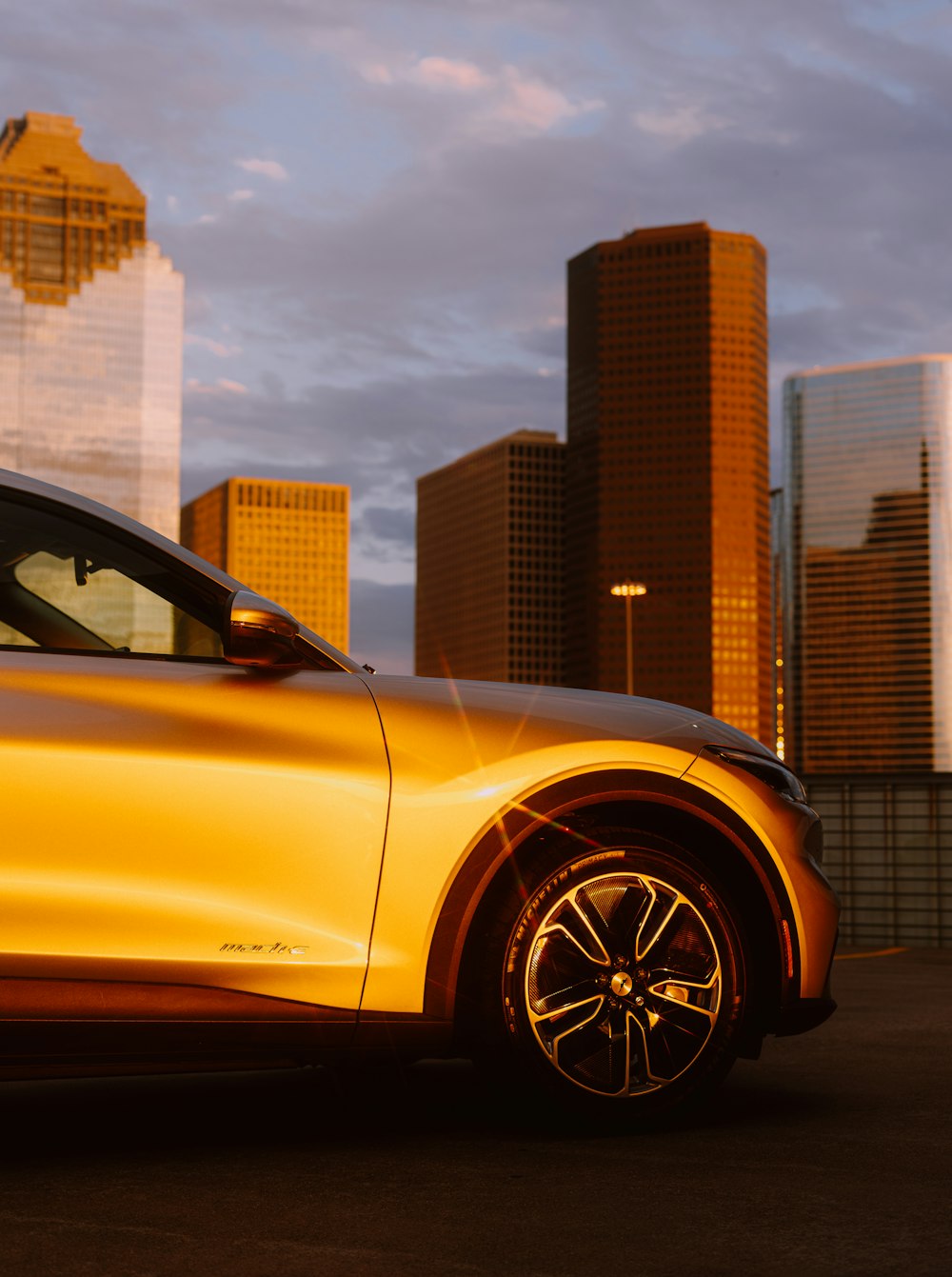 yellow car near brown concrete building during daytime