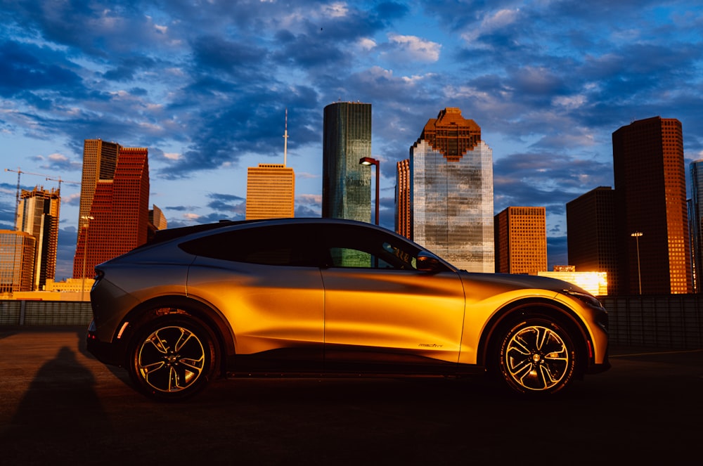 yellow car near city buildings during daytime