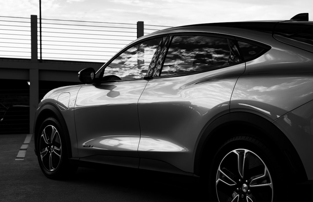 grayscale photo of car in front of garage door