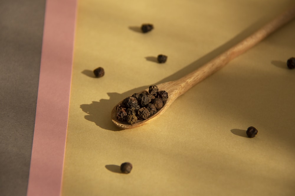 brown wooden spoon with black beans