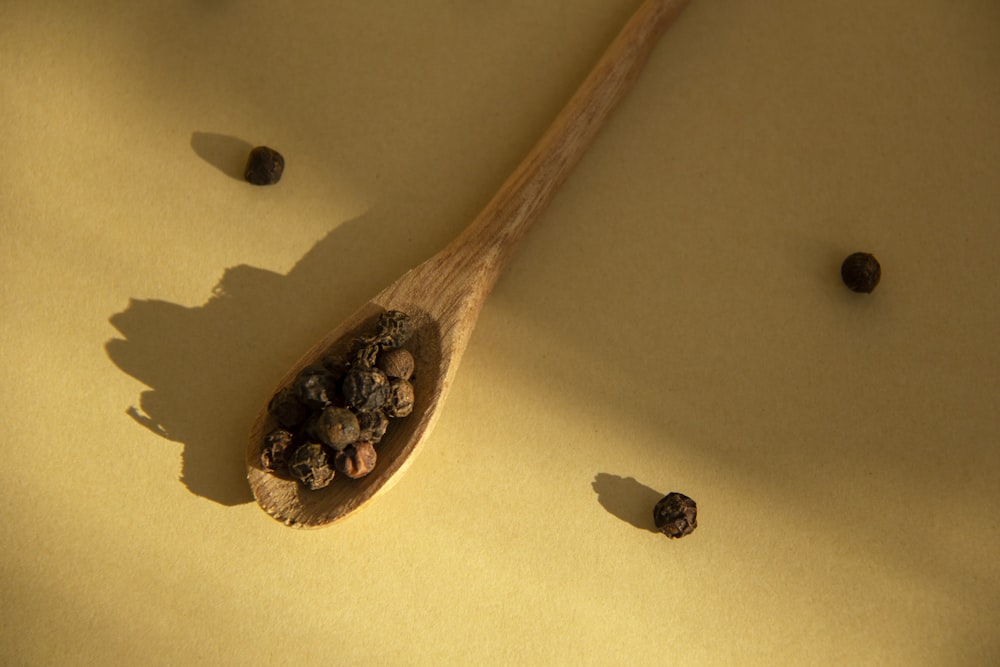 brown wooden spoon on yellow textile