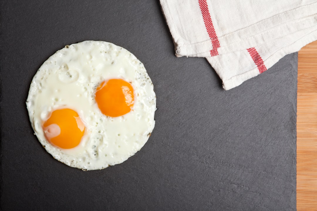 white and yellow egg on black textile