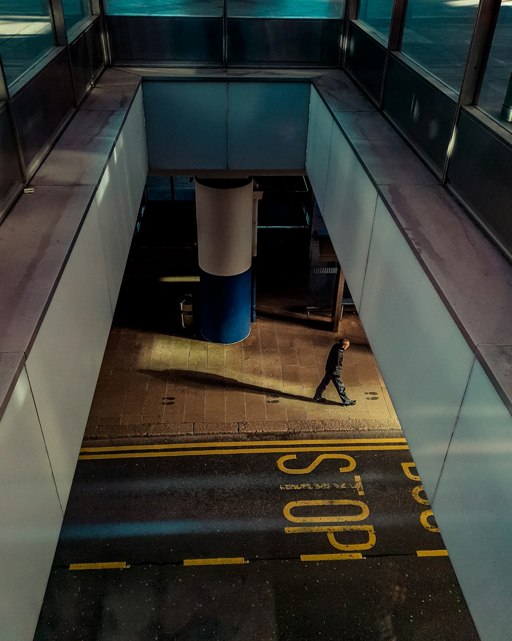 a person walking down a hallway in a building