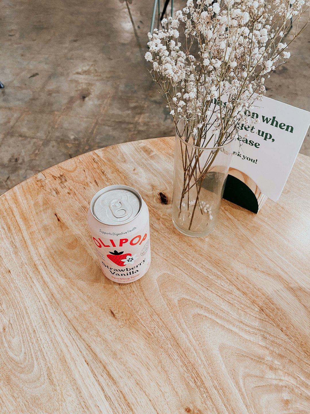 white and red labeled can beside white flower