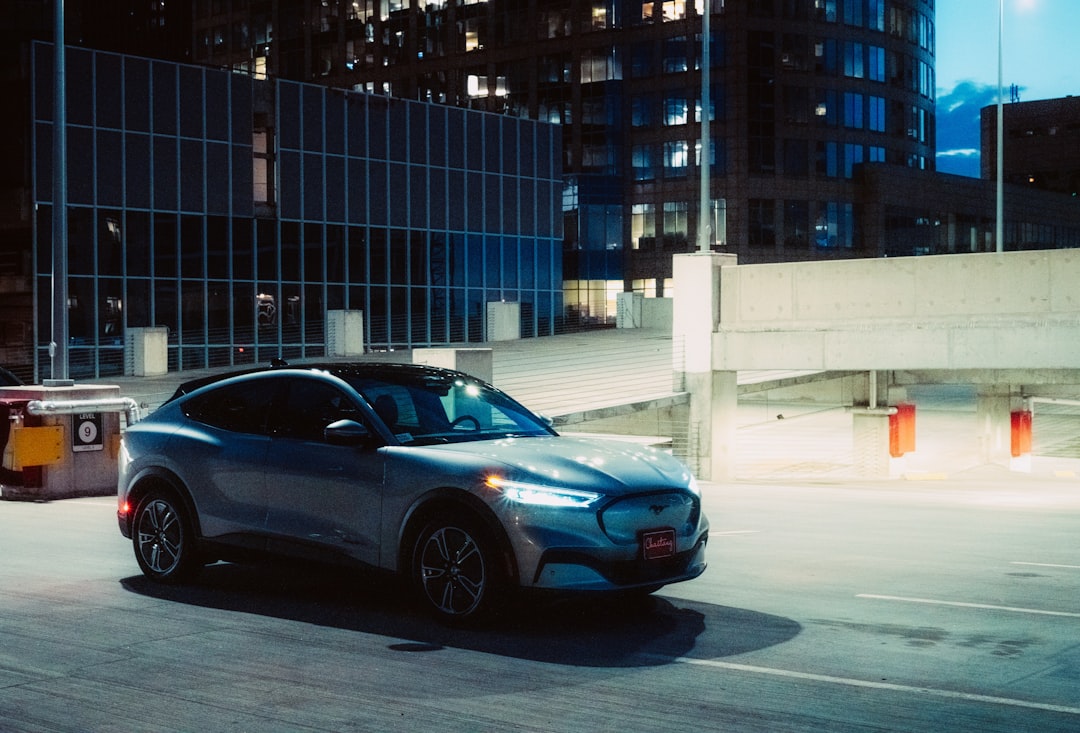 blue coupe parked near building during daytime