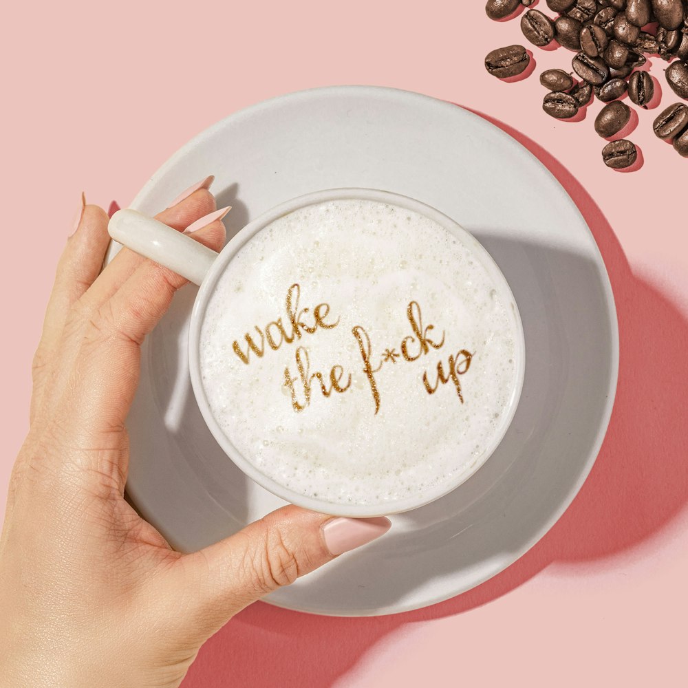 white ceramic mug with coffee beans