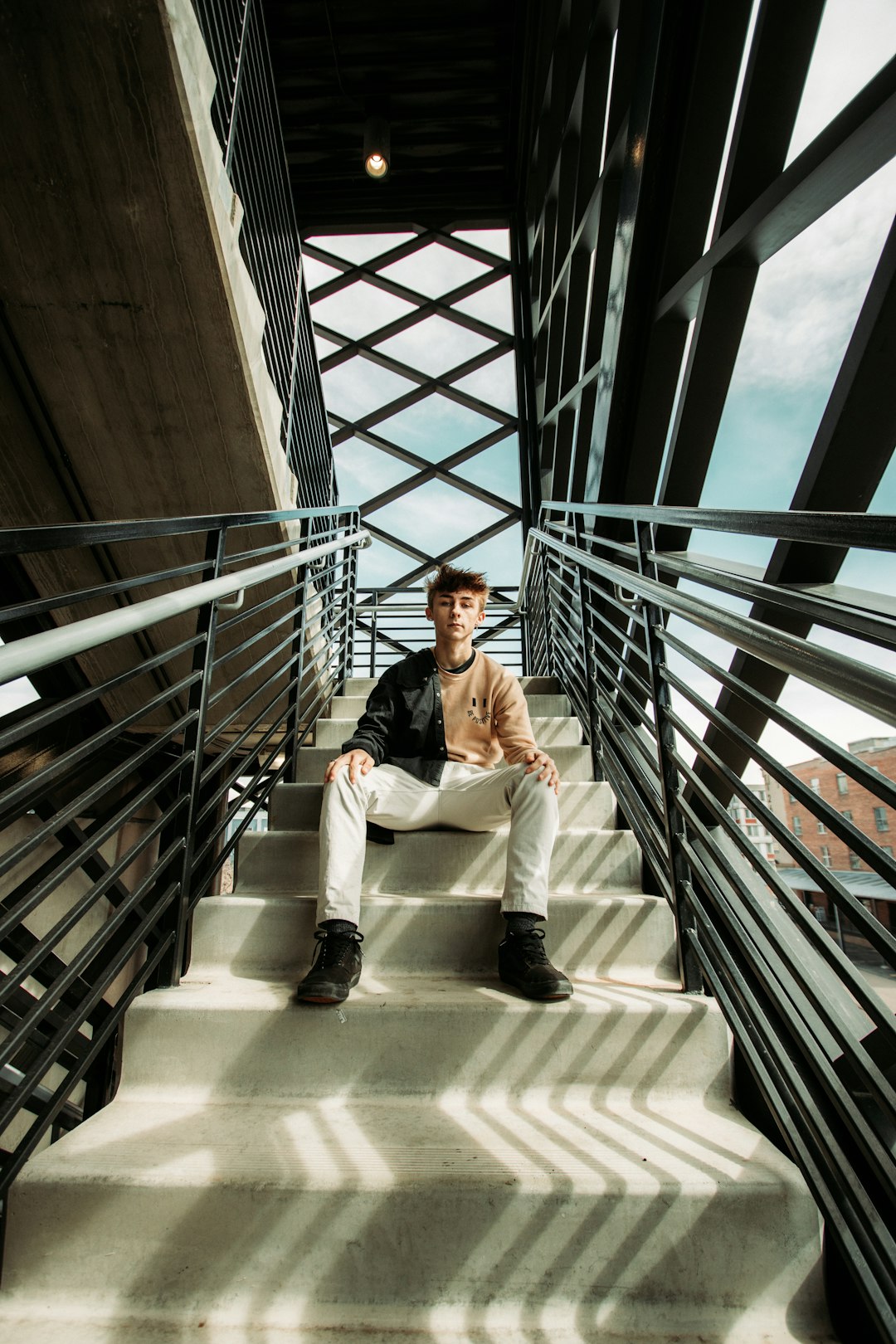 woman in white blazer sitting on white concrete staircase