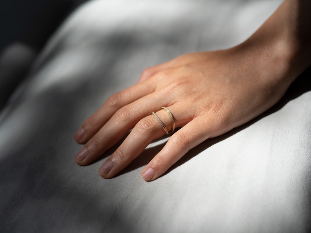 person wearing gold wedding band