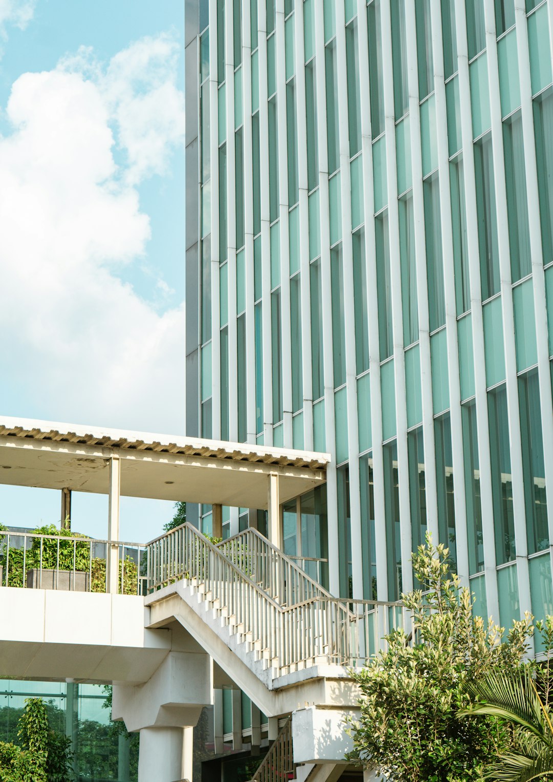 white concrete building near green trees during daytime