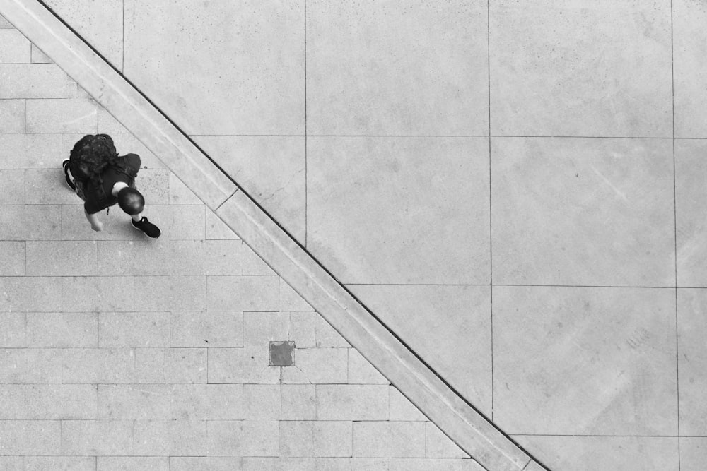 person walking on white concrete pavement