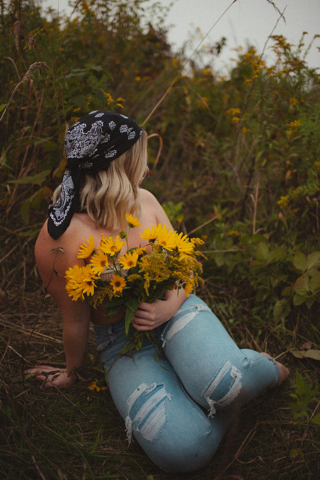 woman in yellow dress holding yellow flowers