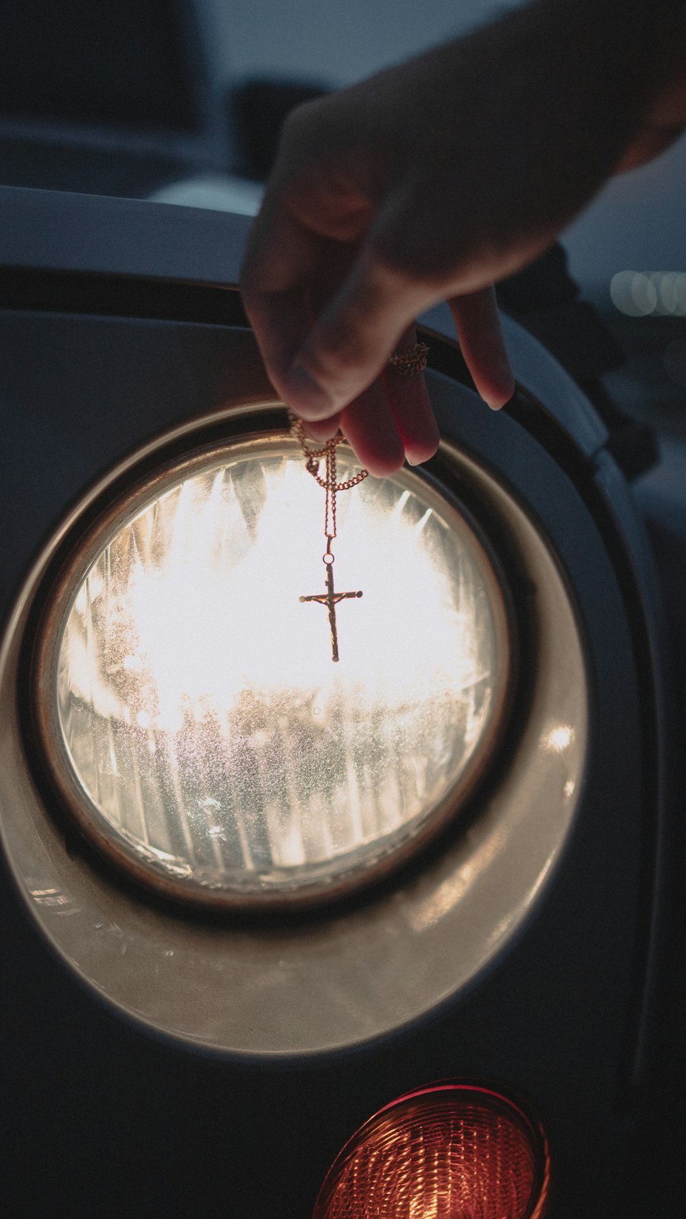 person holding round mirror with silver frame