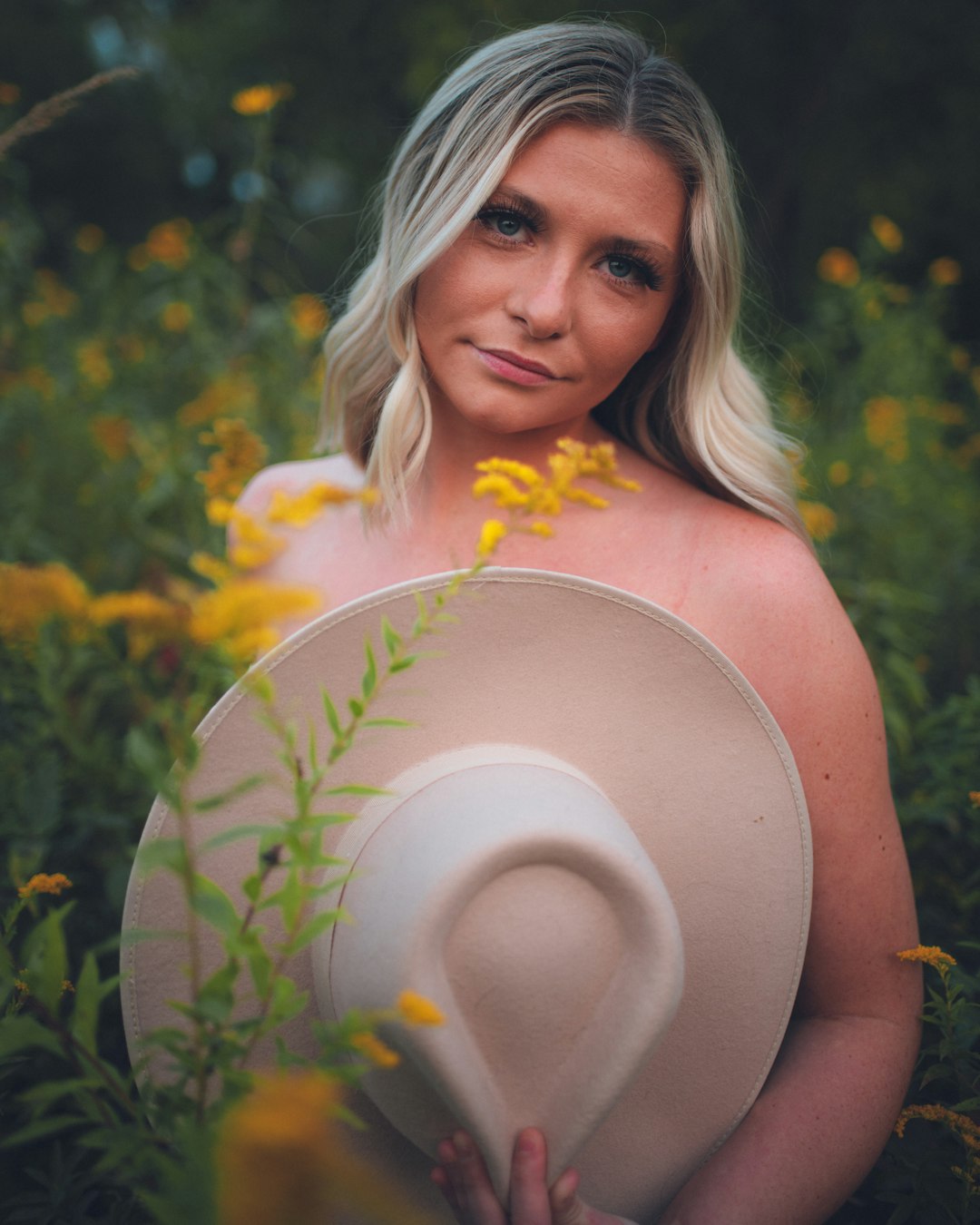 woman in orange tank top holding white round disc