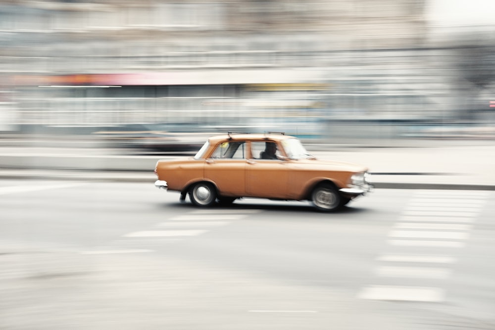 yellow and black sedan on road