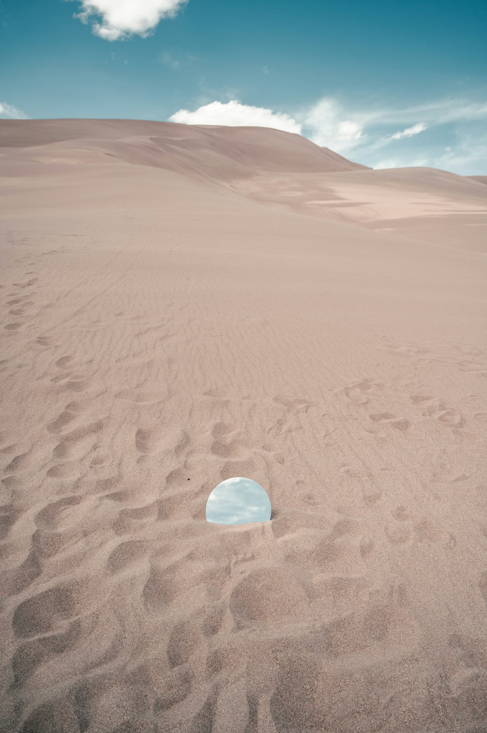 茶色の砂の上の透明なガラスのボール