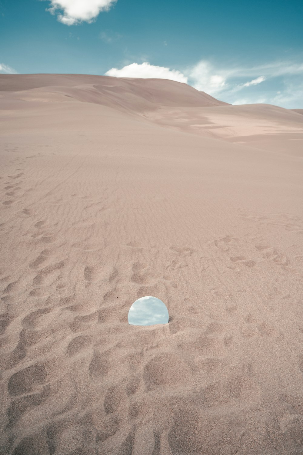 clear glass ball on brown sand