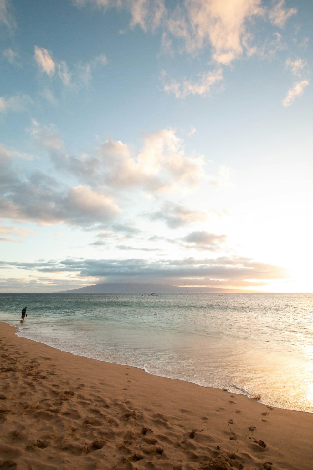 person standing on beach during daytime