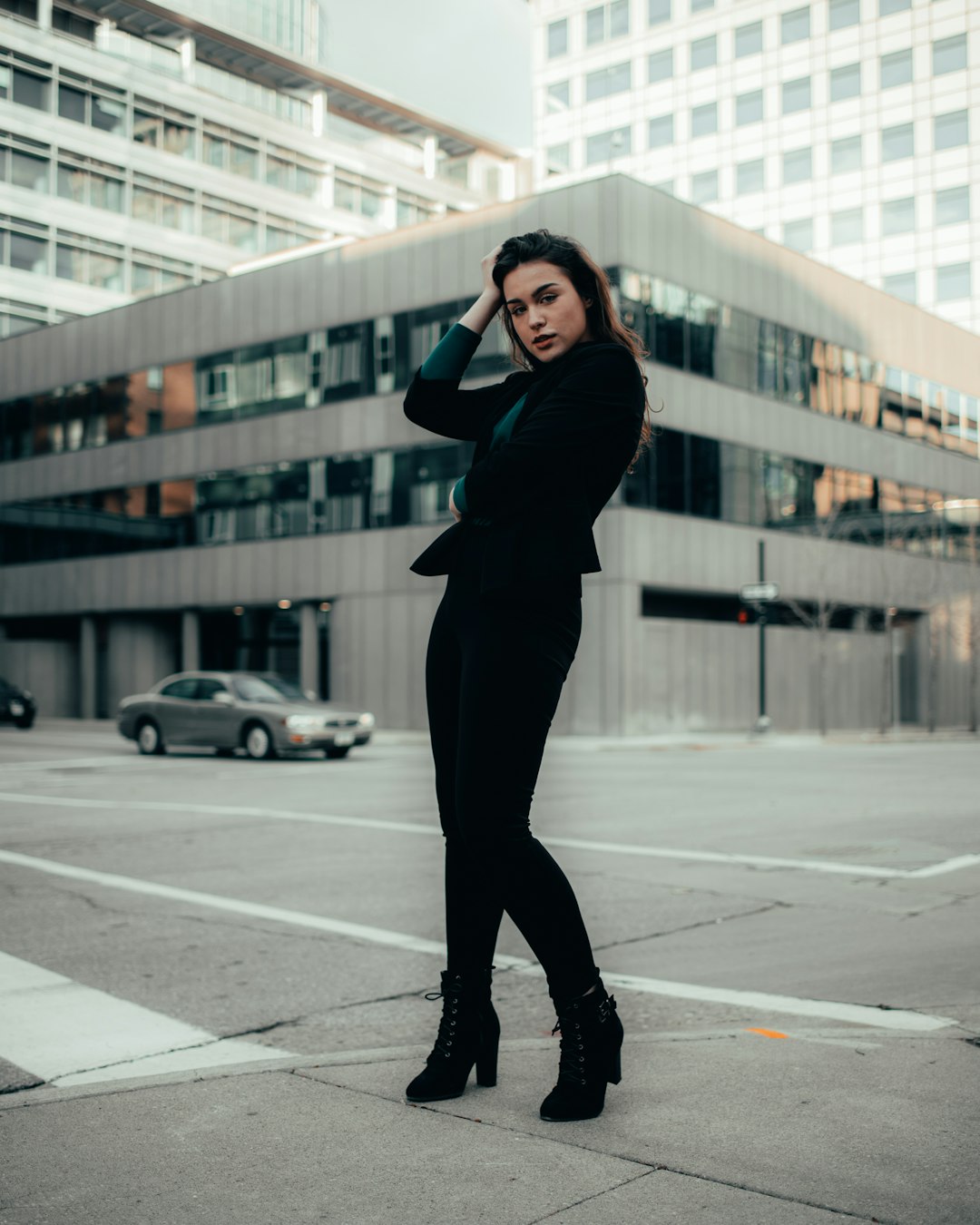 woman in black long sleeve shirt and black pants standing on road during daytime