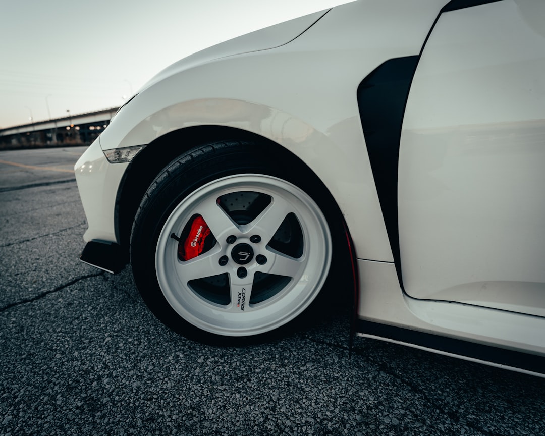 white car on gray asphalt road during daytime