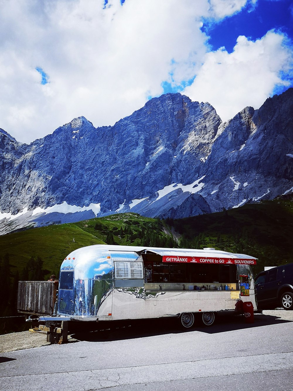 rot-weißer Bus in der Nähe des Berges tagsüber