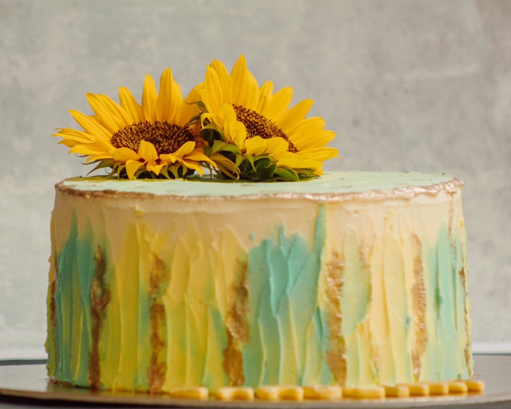 yellow and white cake with yellow flower