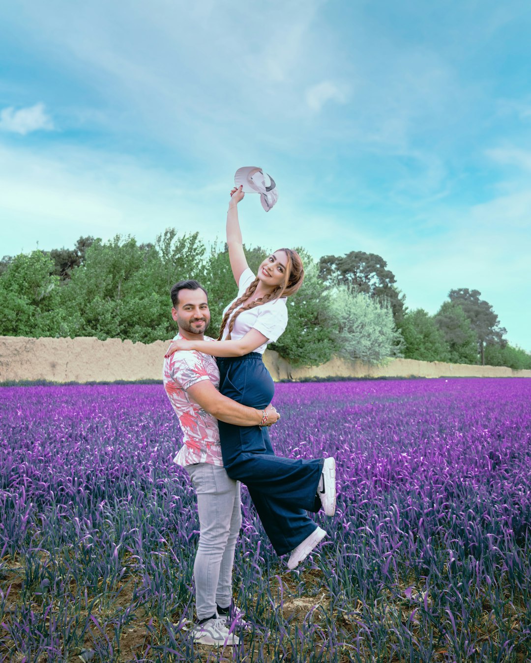 woman in blue tank top and blue denim jeans carrying girl in pink tank top on on on on on