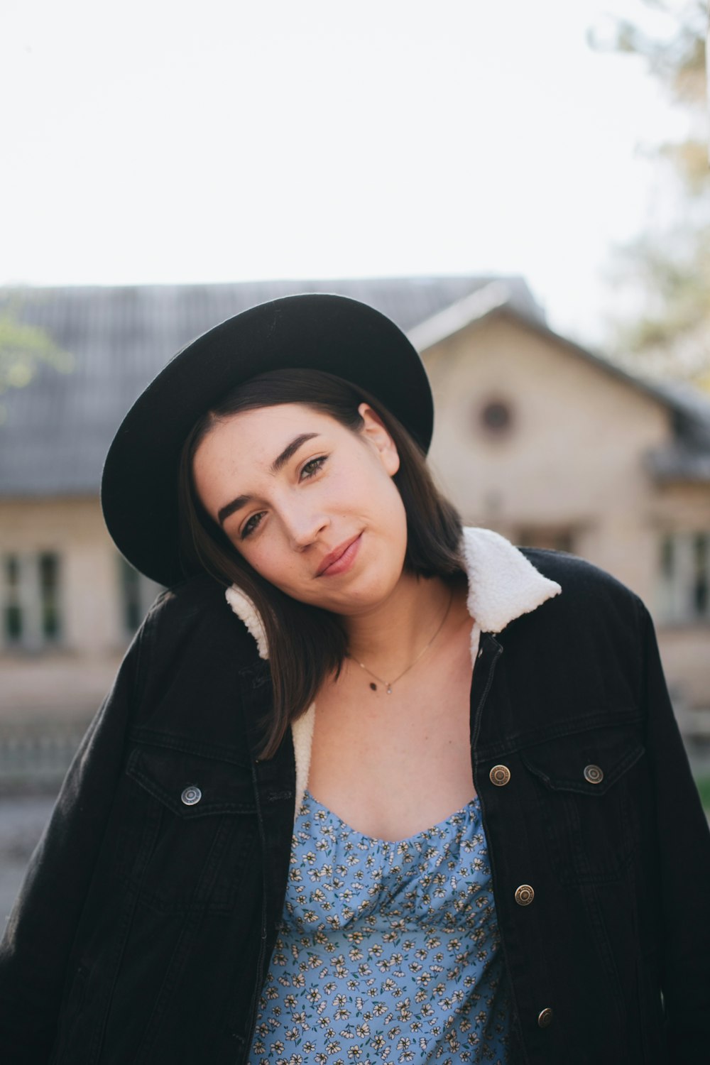 woman in black jacket wearing black hat