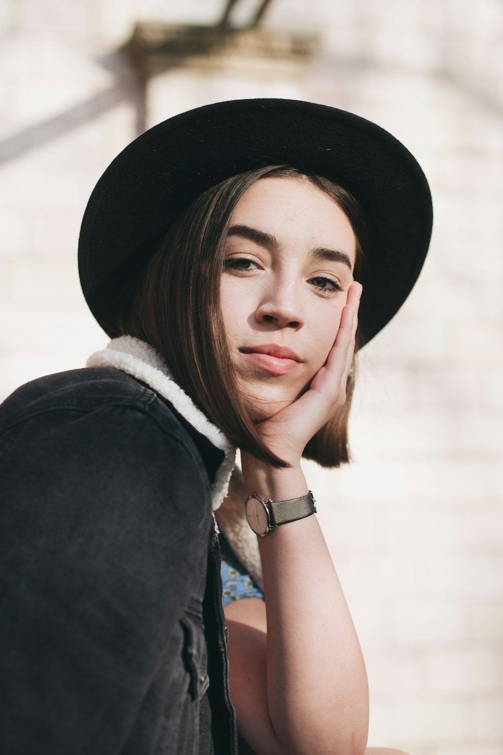 woman in black hat and blue sleeveless top