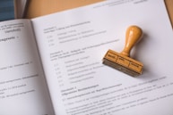 brown wooden hand tool on white printer paper