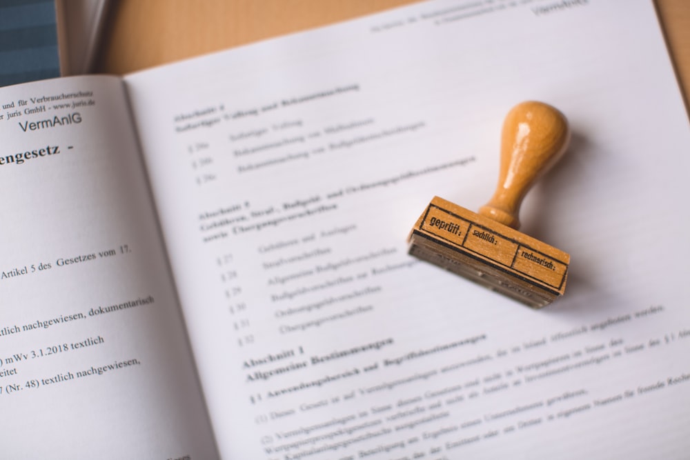 brown wooden hand tool on white printer paper