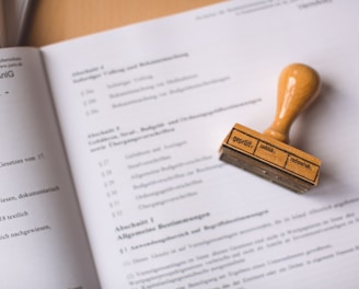 brown wooden hand tool on white printer paper