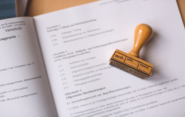 brown wooden hand tool on white printer paper