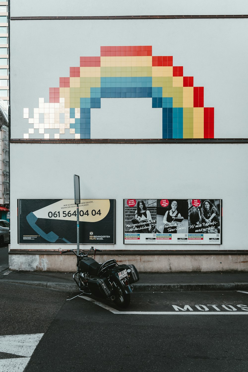 black motorcycle parked beside white wall