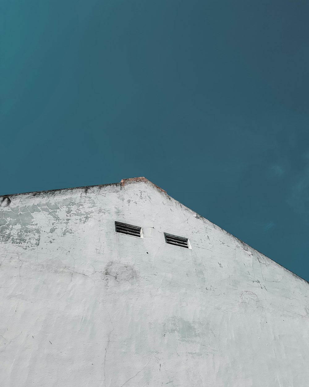 white concrete wall under blue sky during daytime