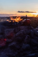 An outdoor kiln glowing warmly during the firing process at dusk.