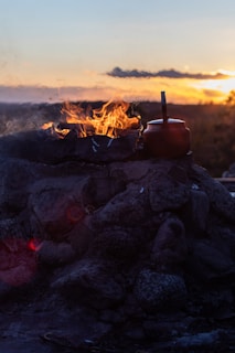 An outdoor kiln glowing warmly during the firing process at dusk.