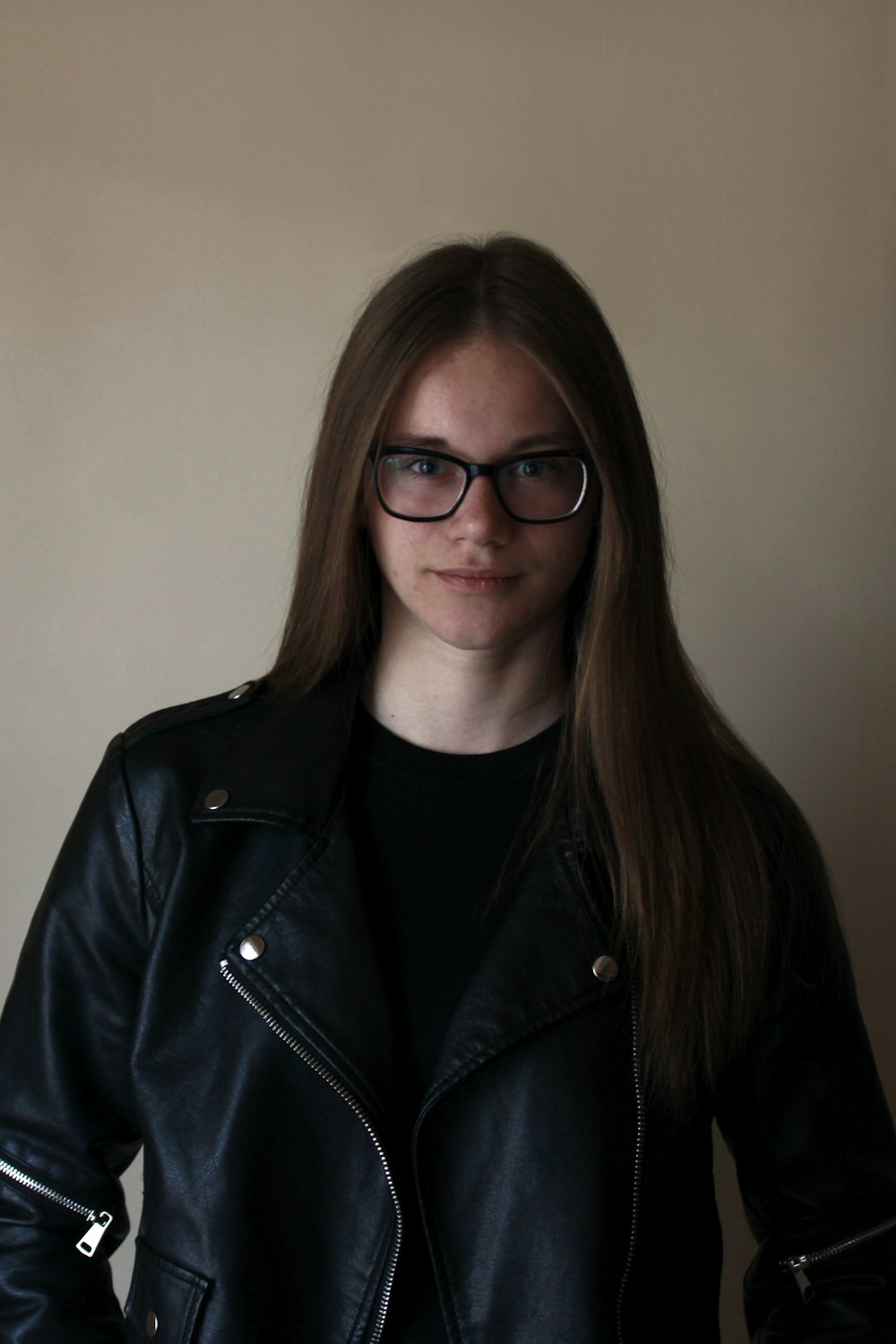 woman in black leather jacket wearing black framed eyeglasses
