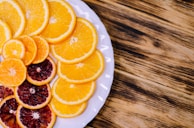 Freshly sliced citrus fruits arranged artfully on a rustic wooden table.