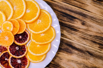 Freshly sliced citrus fruits arranged artfully on a rustic wooden table.