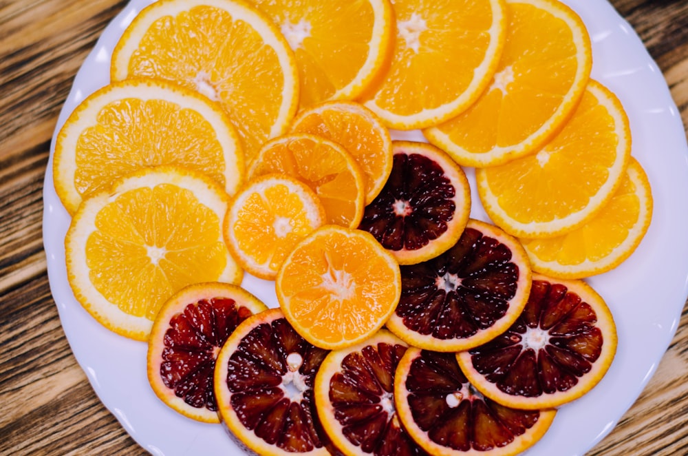 sliced orange fruit on white ceramic plate