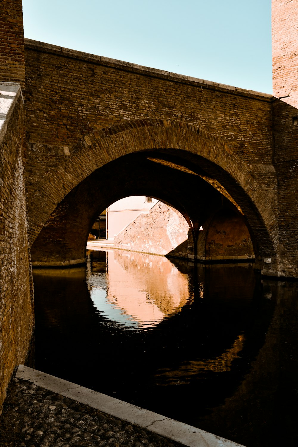 brown concrete bridge over river during daytime