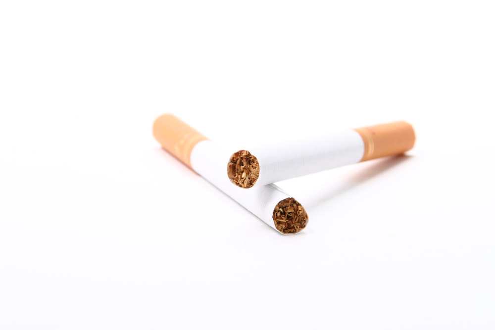 white and orange cigarette stick