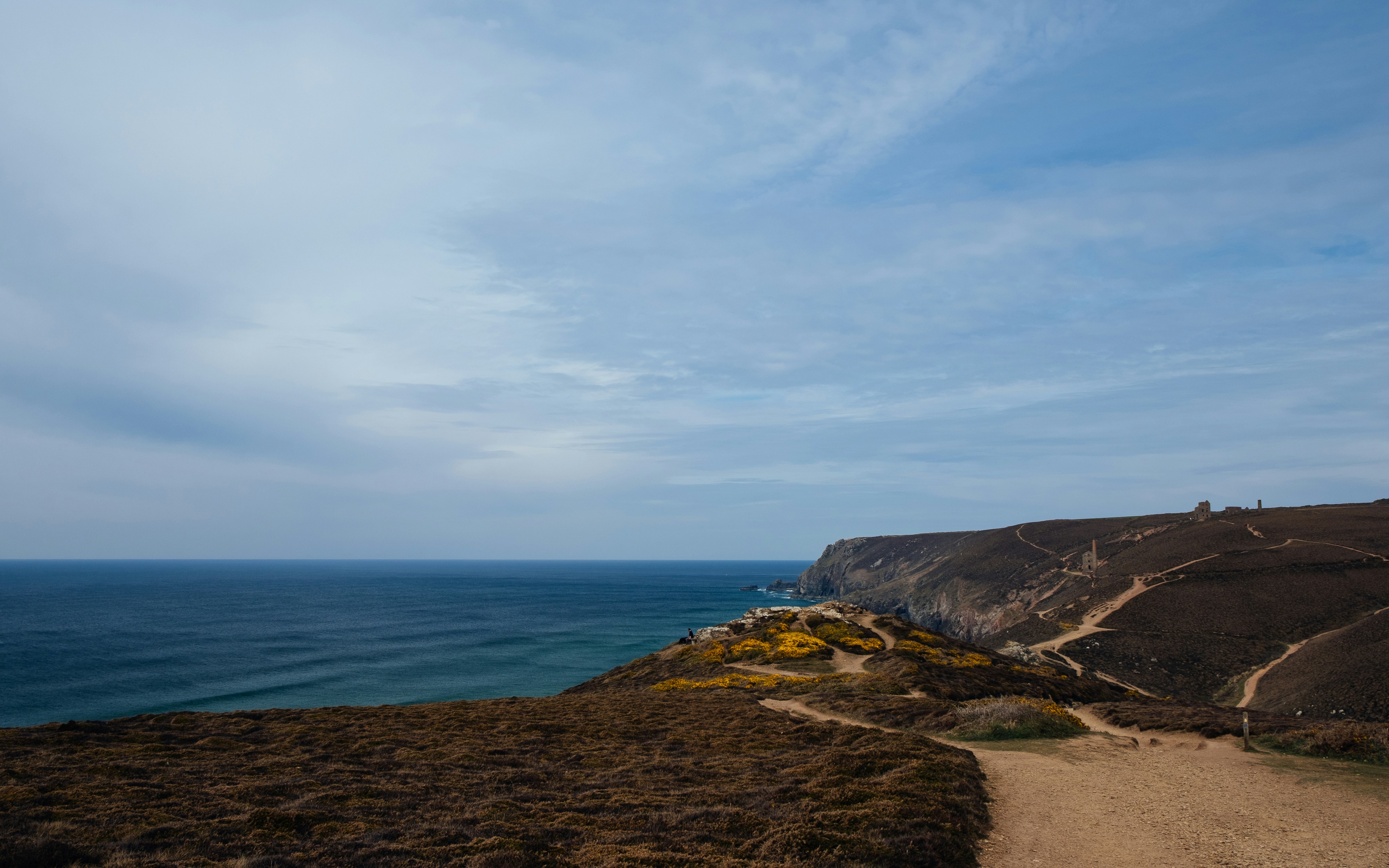 brown rock formation near body of water during daytime