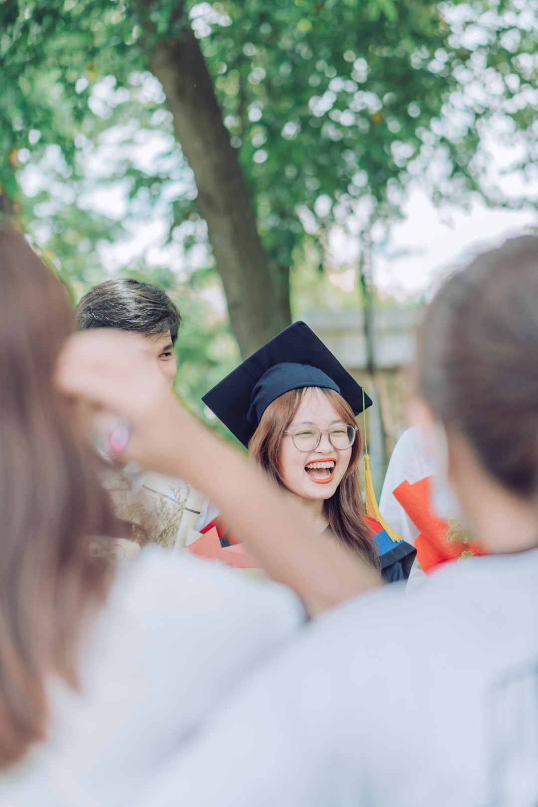 woman in white dress wearing black academic hat