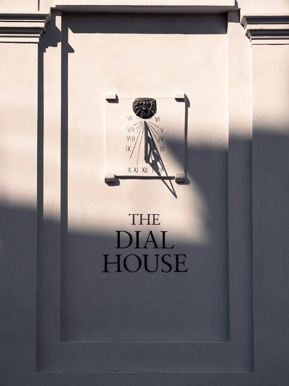 the dial house sign on the side of a building