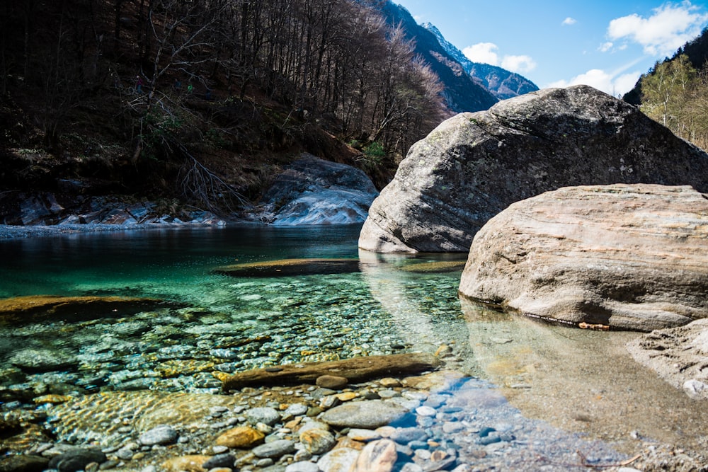 brown rock formation beside river during daytime