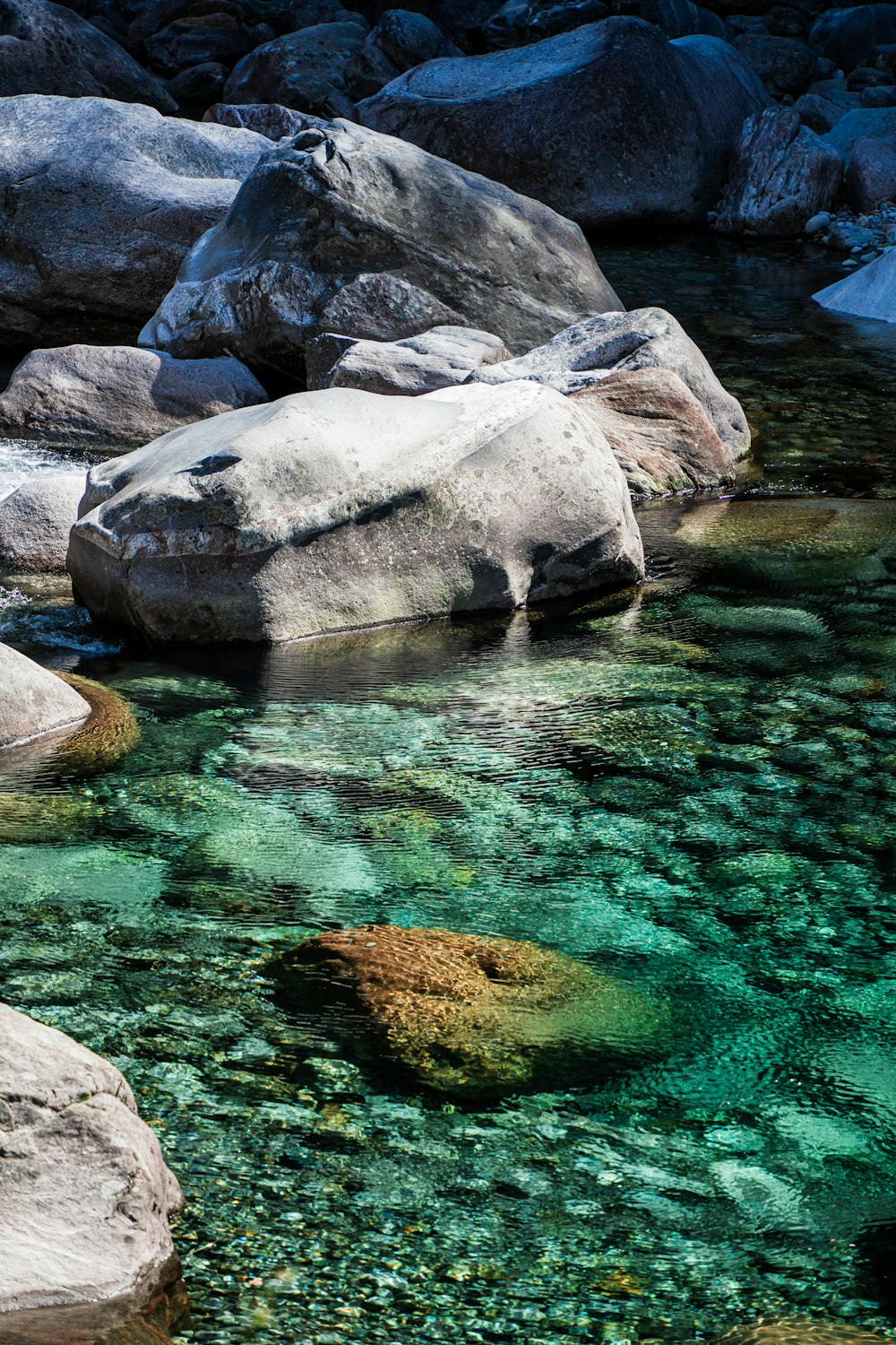 gray rocks on body of water during daytime