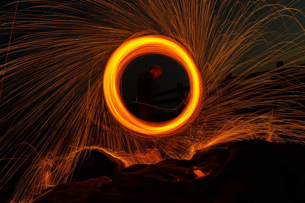 time lapse photography of person standing on brown rock