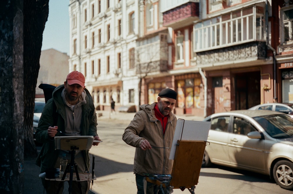 man in brown jacket and red knit cap holding brown box