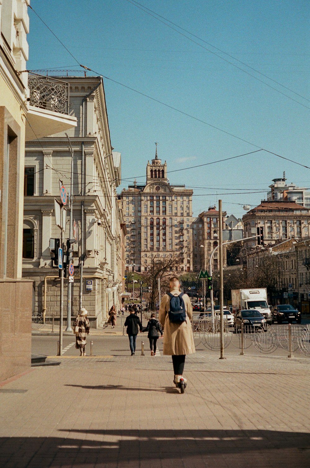 people walking on sidewalk near building during daytime